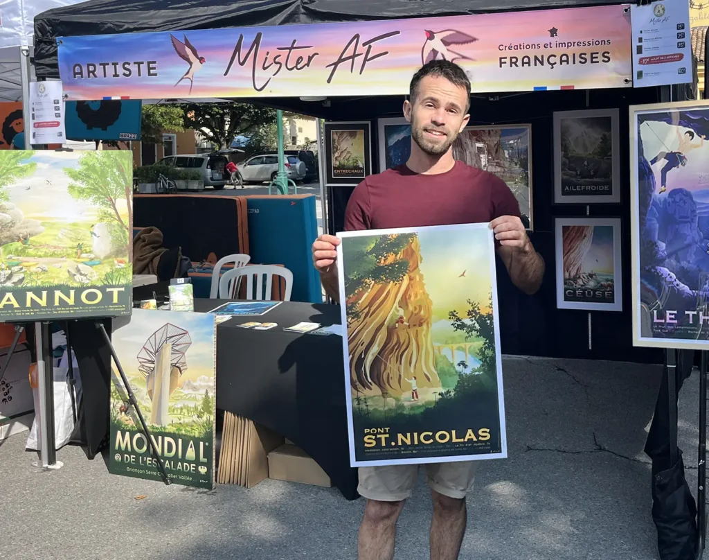 Mister AF, l'artiste devant son stand d'affiches d'escalade